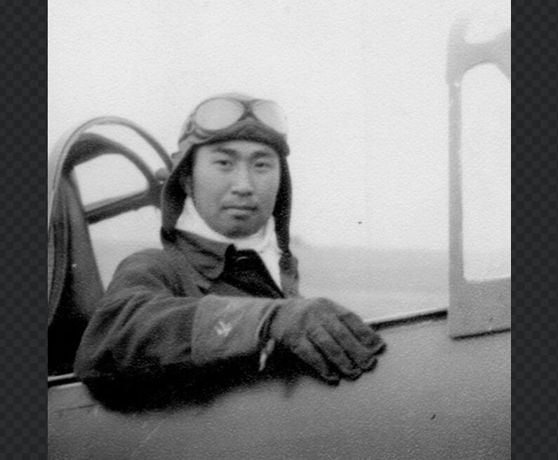 レシプロ戦闘機のコクピットから微笑むパイロット