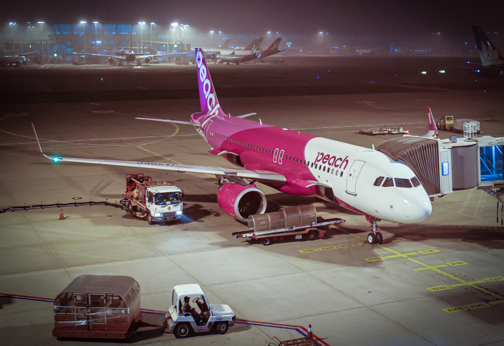 夜の空港で待機、整備中の旅客機